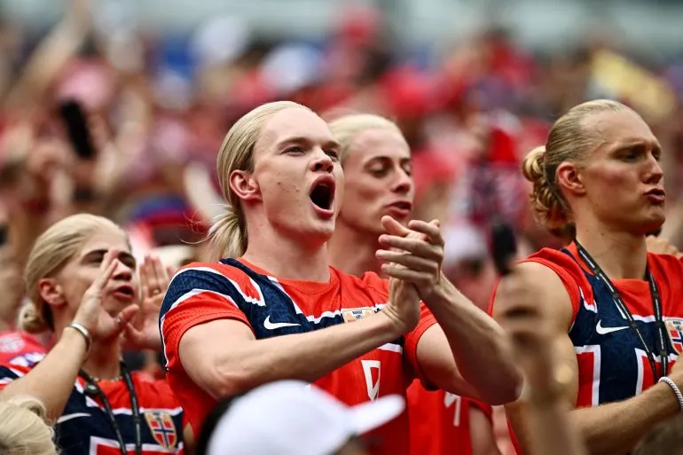 Norway fans react inside the stadium before the match