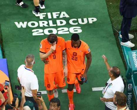 Wout Weghorst and Denzel Dumfries walk off the field