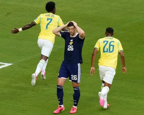 Vinícius Júnior and Rayan celebrate as Scott McKenna holds his head in his hands