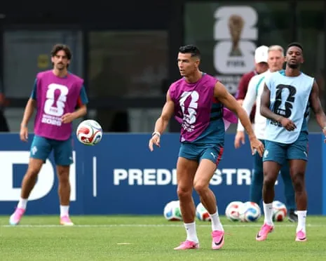 Cristiano Ronaldo, wearing a purple training top, trains with his Portugal teammates.