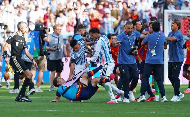 Leandro Paredes wrestles Spain’s Gavi to the ground after full-time