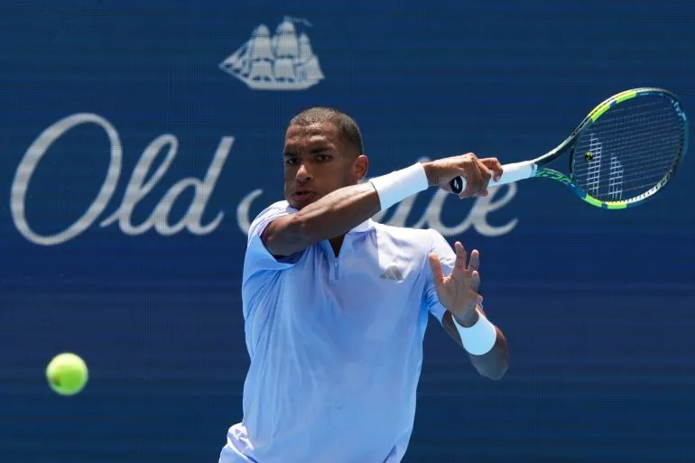 Felix Auger-Aliassime returns a shot against Stefanos Tsitsipas during their second-round match-up at the Cincinnati Open